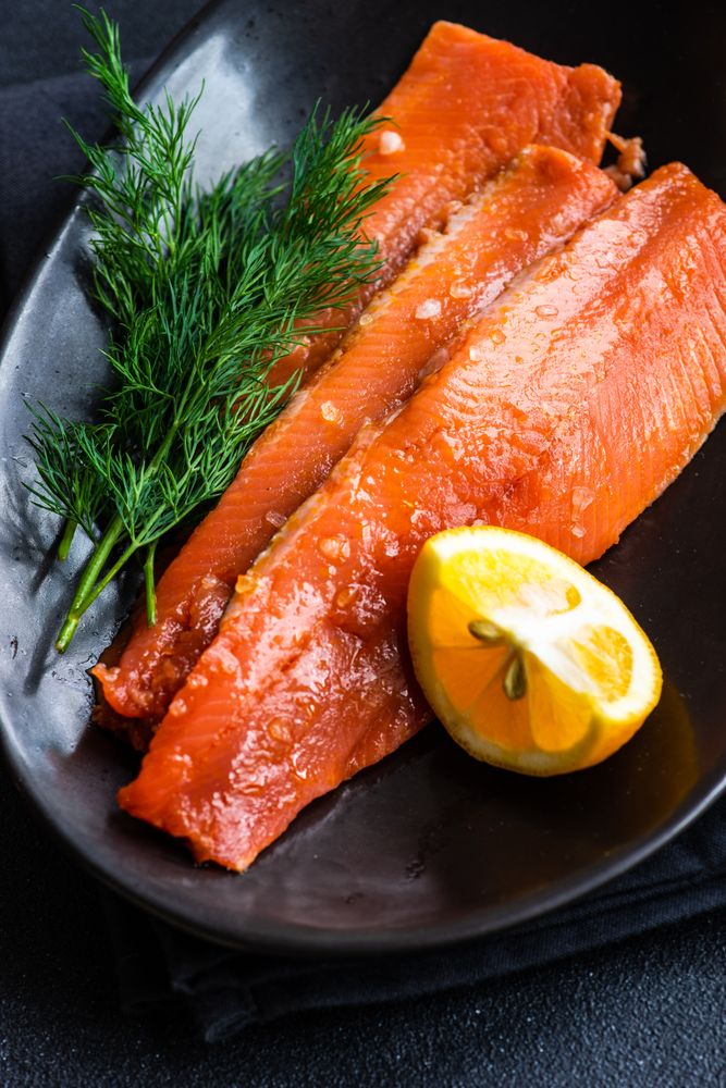 Herring fish on plate served with dill and lemon