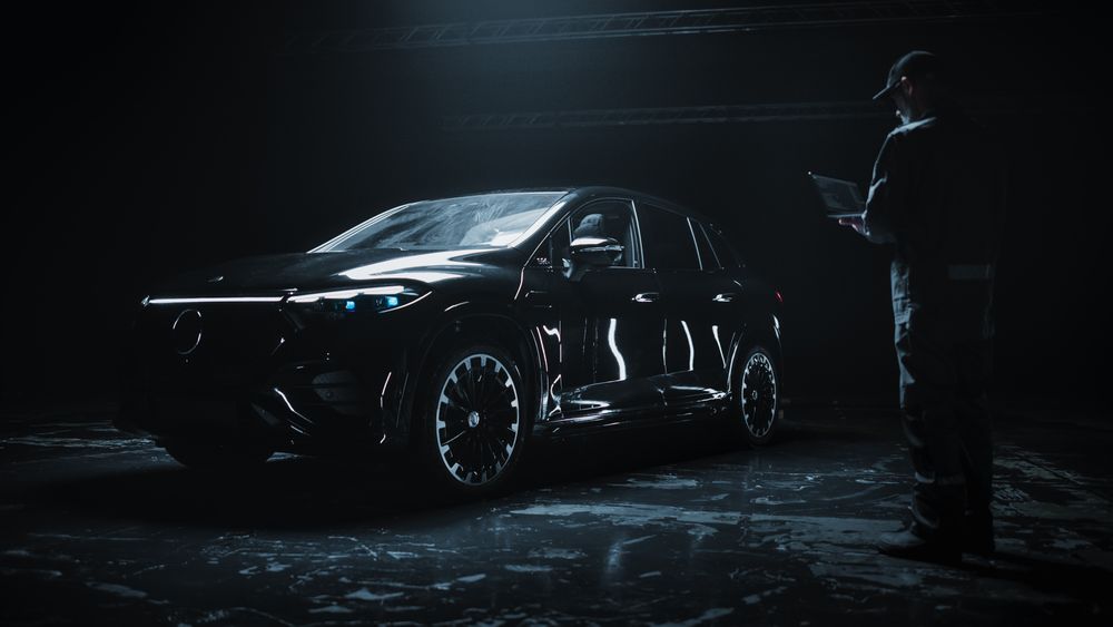 Car Manufacturing Engineer Using Laptop Computer, Programming a Brand New Electric SUV at a Dark Research and Development Facility.