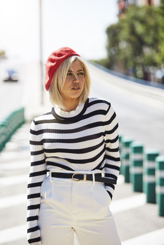 female in red beret outdoors