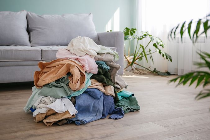 Pile of carelessly scattered clothes on floor.