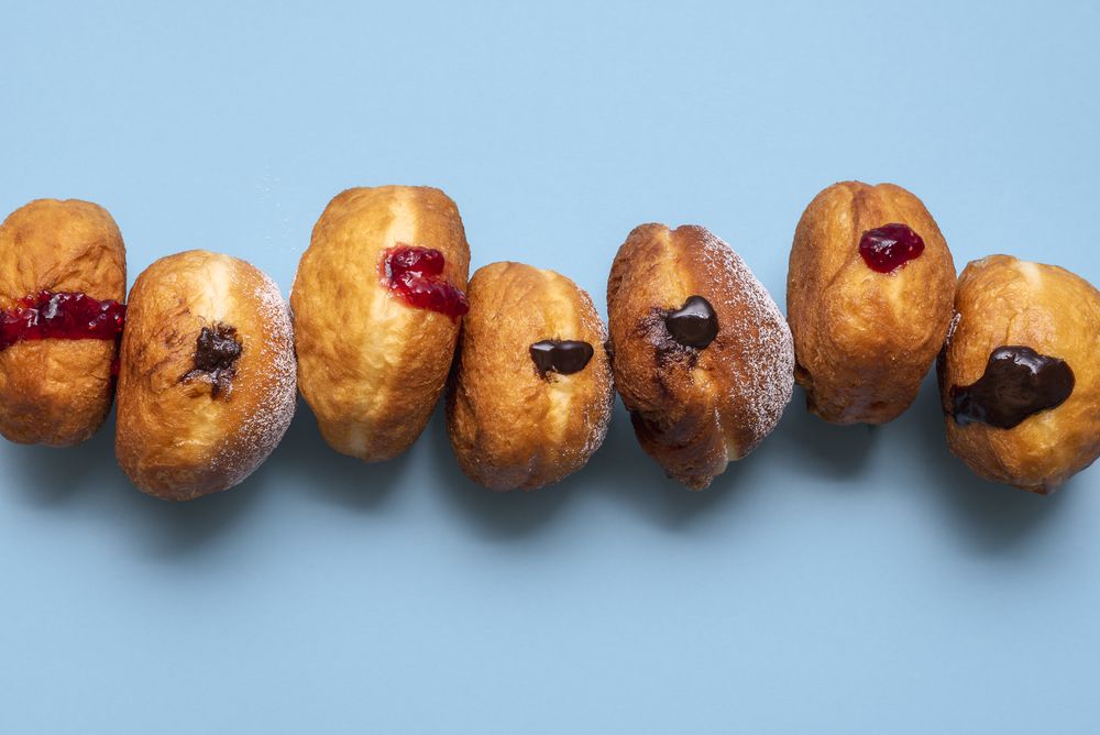 Homemade jelly doughnuts in a row