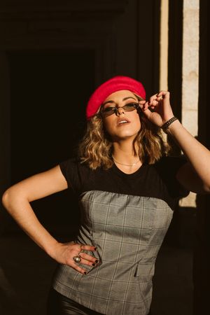Stylish female standing near building wall