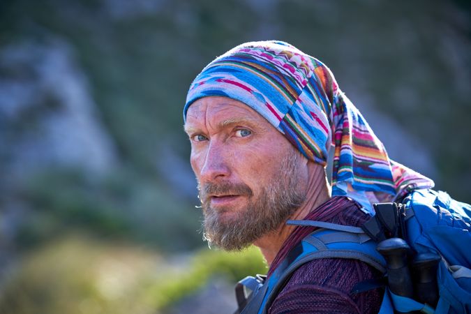 Mature traveling man looking away in nature