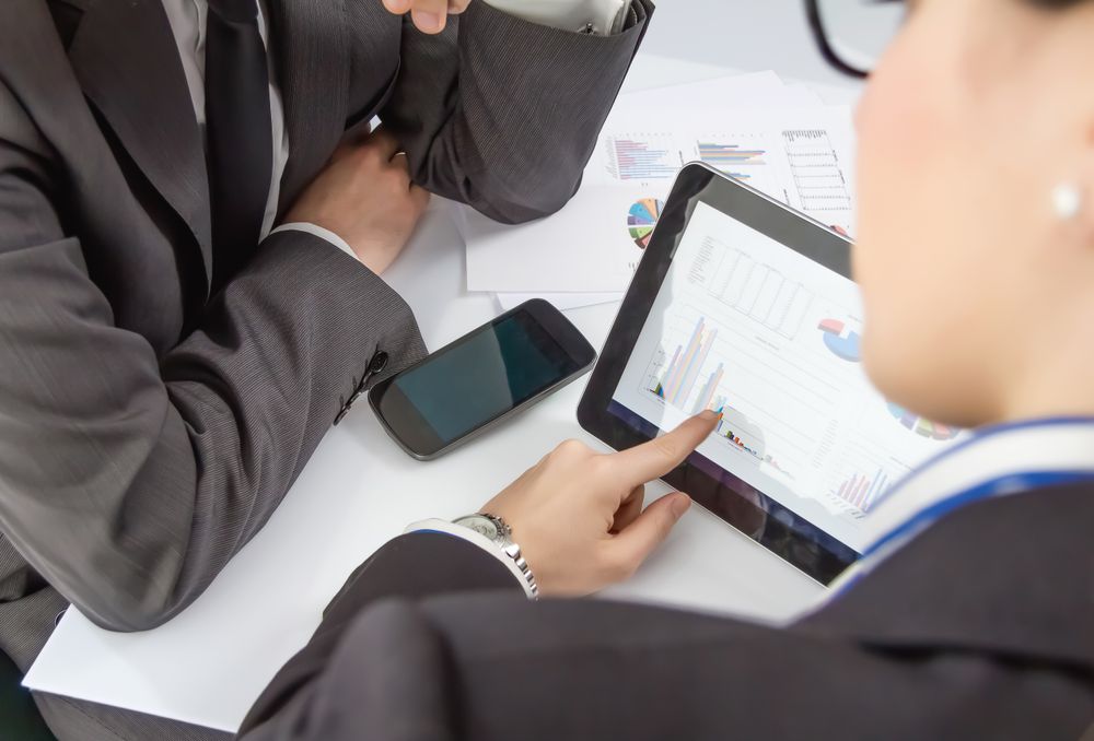 Businesswoman showing documents in digital tablet