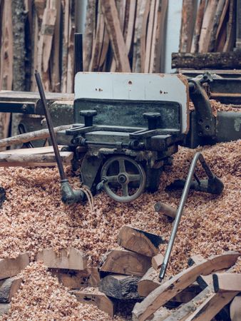 Lathe near heap of wood