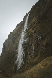 Huge mossy cliff with cascade