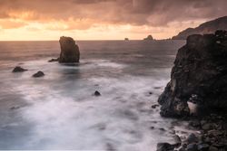 Amazing stone shore and pink sky with clouds