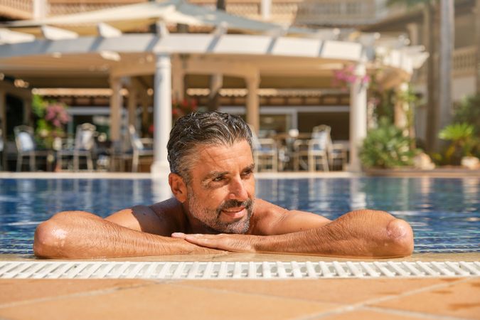 Mature man resting in swimming pool