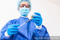 Doctor in PPE holding coronavirus vaccine 43JZr5
