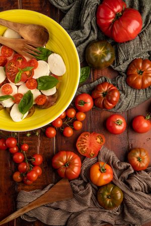 Tomatoes and napkins near bowl with salad