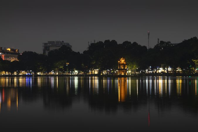 Hoan Kiem Lake at night with the lights of Hanoi, in Vietnam