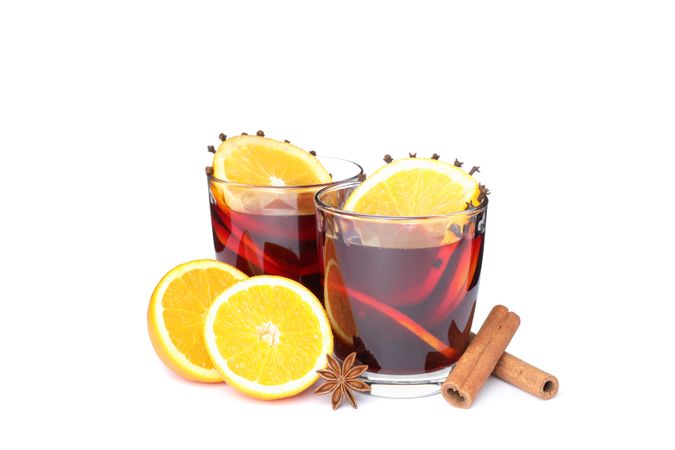 Glasses of tasty mulled wine with orange isolated on plain background