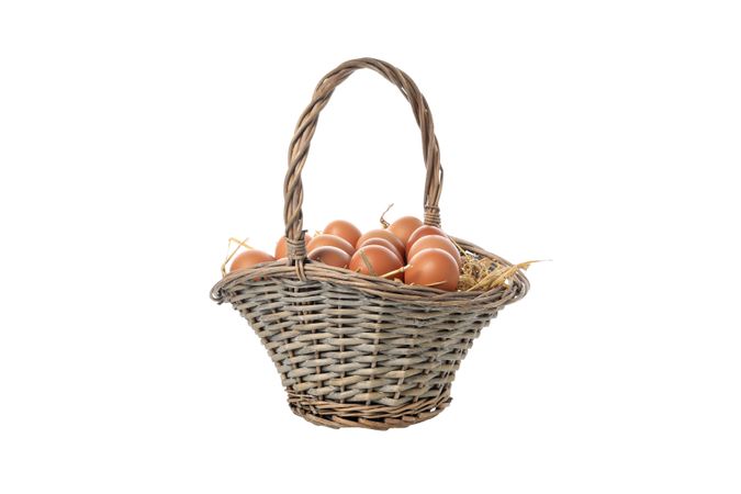 eggs in a wicker basket with handles, isolated on blank background.