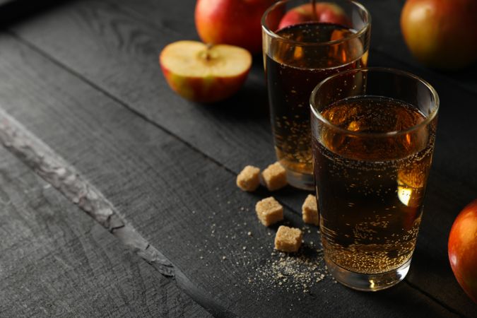 Composition with cider, sugar and apples on wooden background