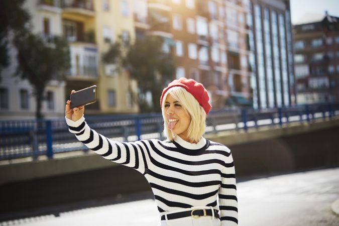 female in red beret taking selfie