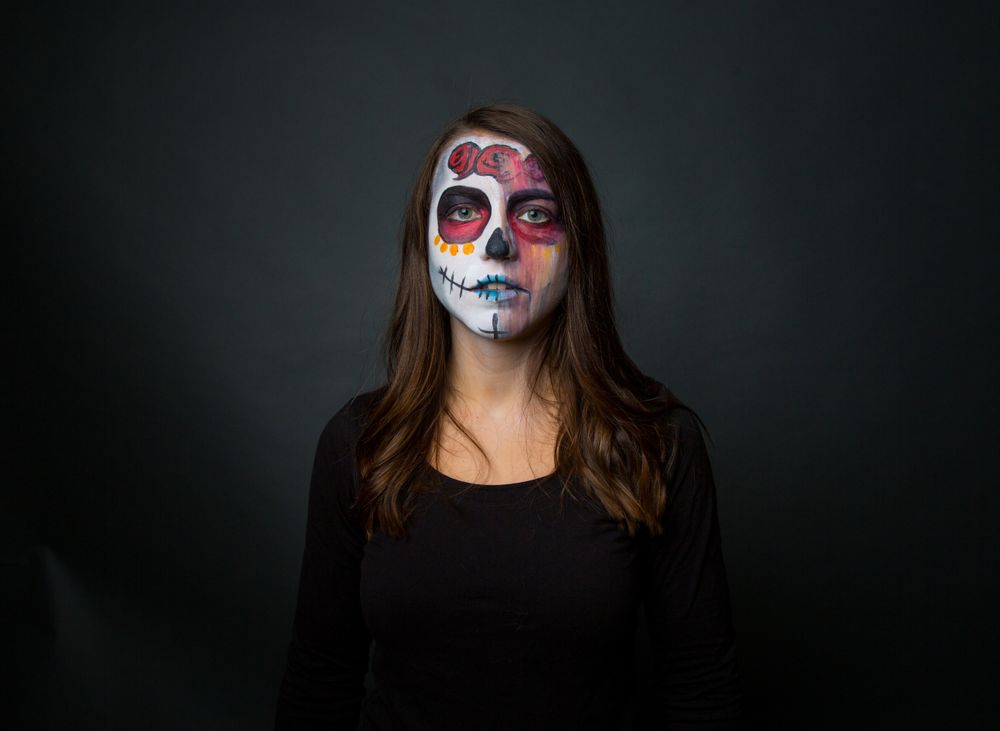 Young woman with creepy face paint