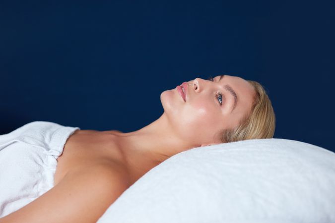 Blonde woman lying back during beauty treatment