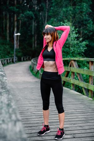 Sportswoman doing stretching arms outdoors
