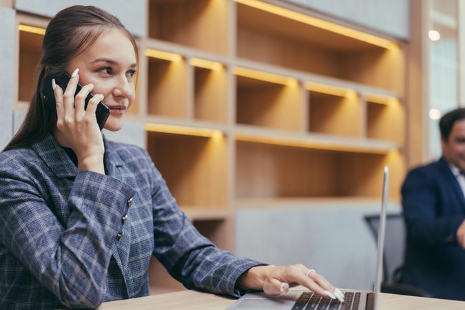 Woman taking phone call in modern office