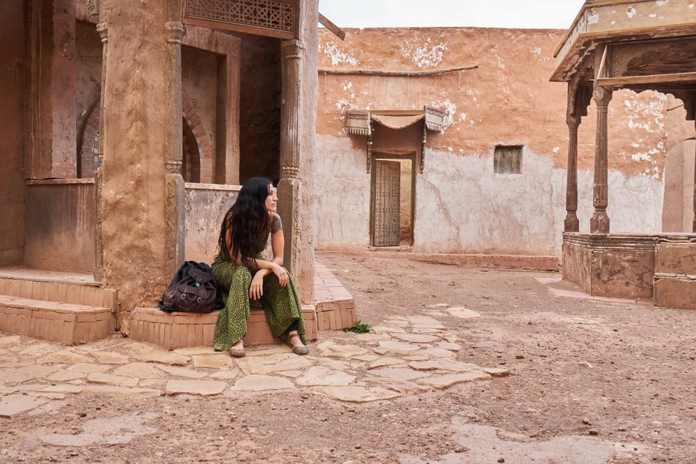 Woman on street between ancient buildings