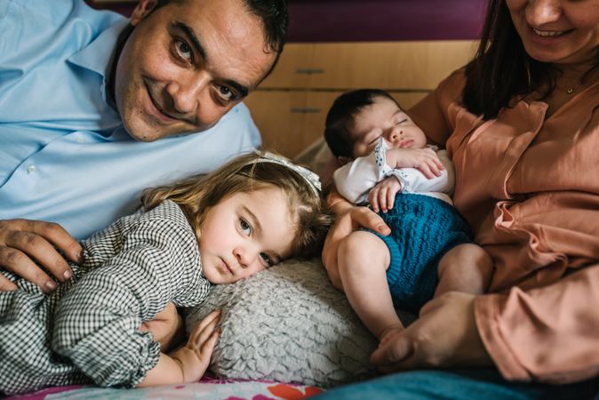 Happy family having fun in bedroom