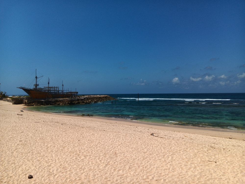 Old sailboat on a beautiful beach
