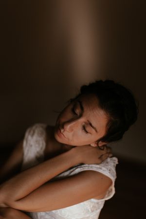 woman sitting in dark room