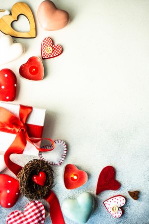 Top view of various Valentine's day items, heart candles, ornaments and gift