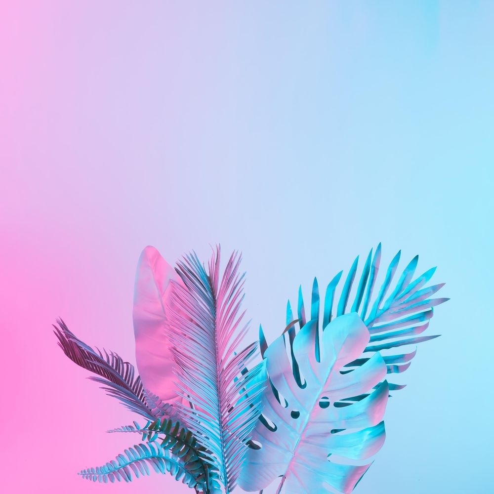 Tropical and palm leaves in vibrant bold gradient holographic colors