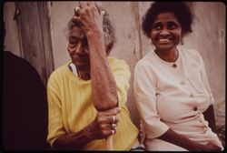 Two older Puerto Rican woman sitting outside