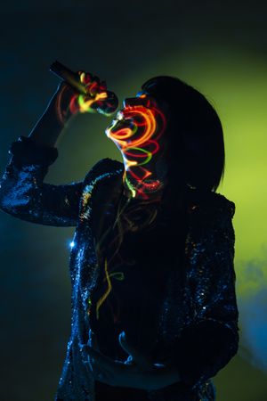Stylish woman singing on stage