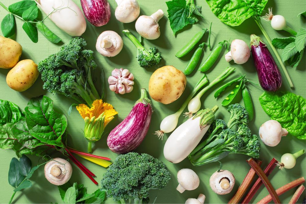 Top view of fresh organic vegetables on green table