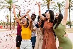 People having fun with confetti at summer party