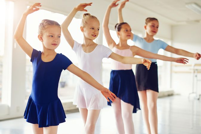 Young ballet students standing in a row