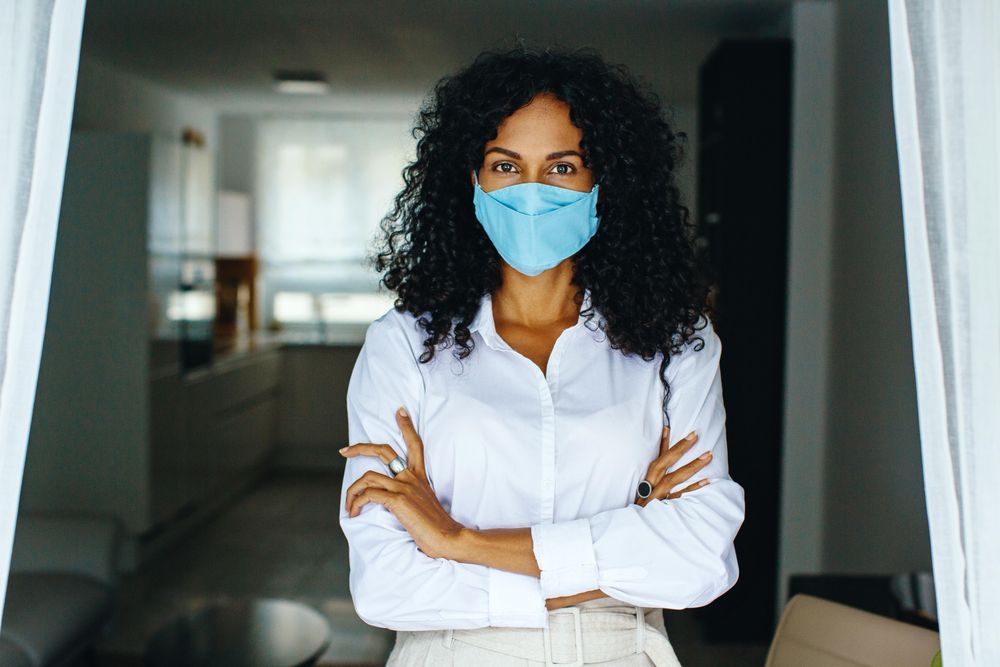 Woman in facemask with her arms crossed