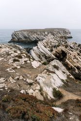 Rocky formations in the island of Baleal on the Atlantic coast in a foggy day. Peniche, Portugal