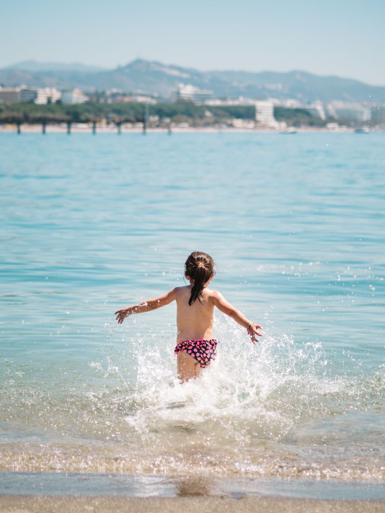 Cheerful girl having fun in warm sea