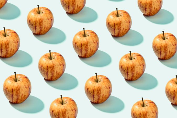 Half apple in row with whole apples