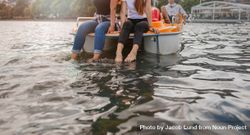 Cropped shot of young women sitting pedal boat front with feet in water 5r3GM4