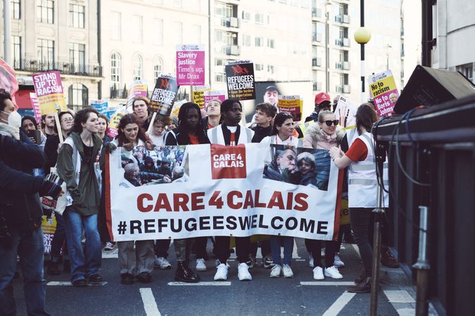 London, England, United Kingdom - March 19 2022: People holding a Care4Calais sign