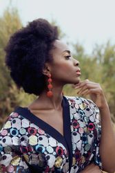 Side view of woman in patterned shirt standing outdoor