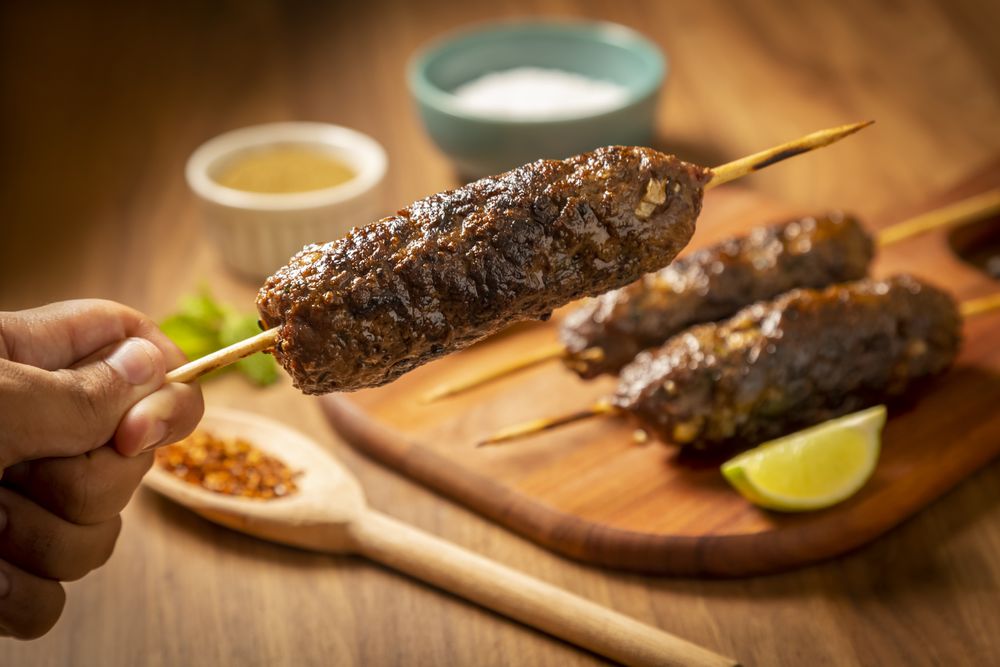 Beef kafta on the wooden board. Kafta, Traditional Arabic cuisine.