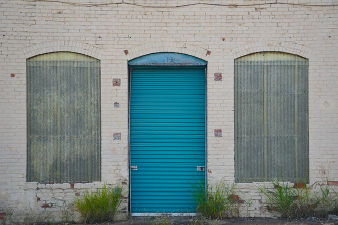 A bricked building with a blue door