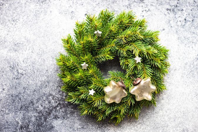 Christmas wreath with decorative stars on marble background