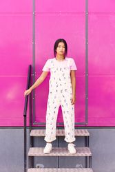 Chinese woman standing on stairs in front of pink trailer