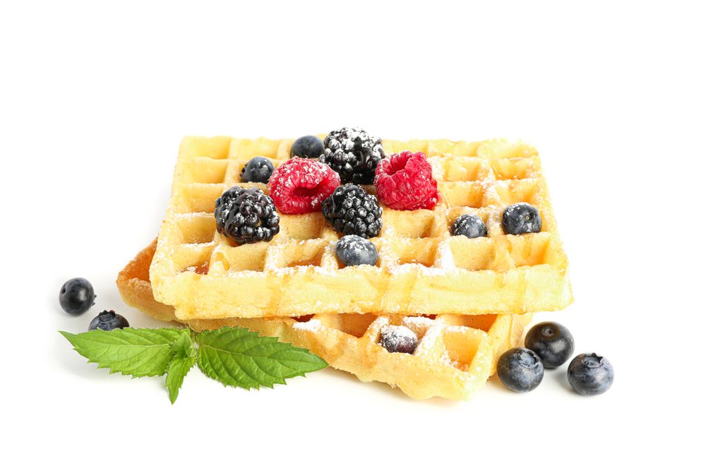 Waffles with berries and mint isolated on blank background