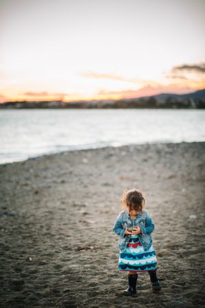 girl with stones at beach