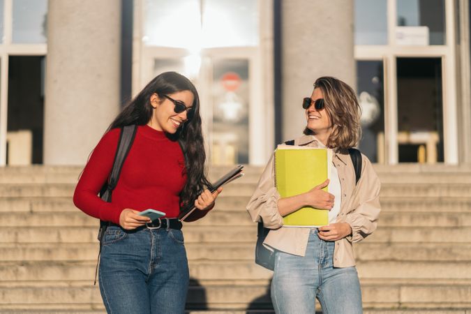 Two students leaving class down the stairs. Blonde and brunette