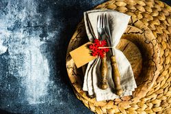 Top view of brown plate on table mat with Christmas snowflake ornament