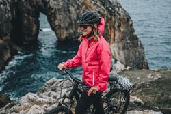 Female bicyclist on rocks